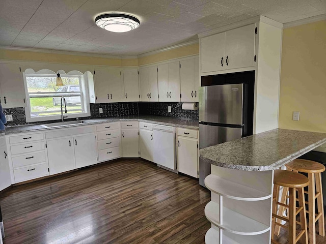 393 Main St, Limestone, ME 04750 - kitchen featuring white dishwasher, a sink, freestanding refrigerator, crown molding, and backsplash