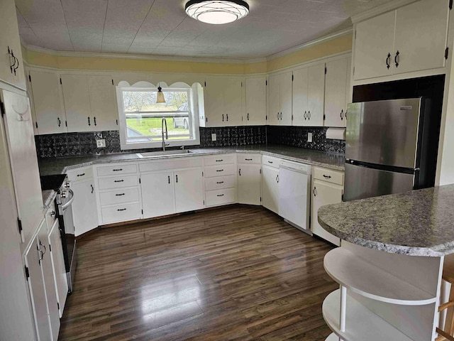 393 Main St, Limestone, ME 04750 - kitchen with stainless steel appliances, a sink, crown molding, dark wood-type flooring, and tasteful backsplash