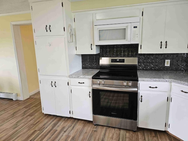 393 Main St, Limestone, ME 04750 - kitchen with electric stove, white microwave, a baseboard heating unit, decorative backsplash, and ornamental molding