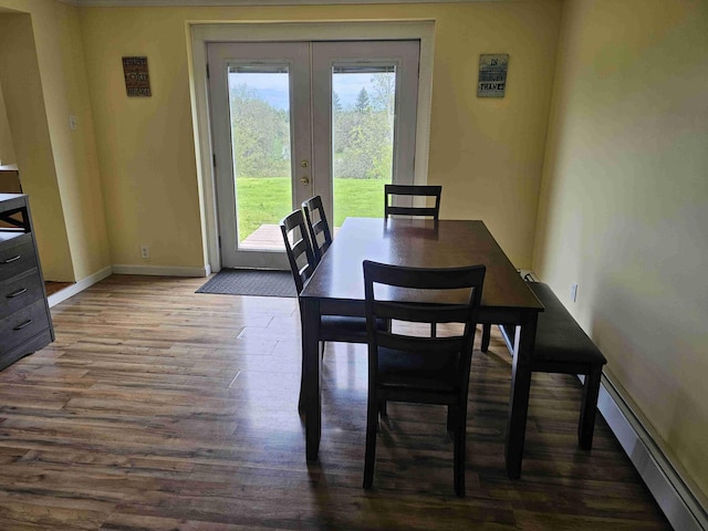 393 Main St, Limestone, ME 04750 - dining room featuring a baseboard radiator, french doors, wood finished floors, and baseboards