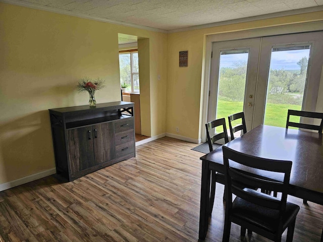 393 Main St, Limestone, ME 04750 - dining room featuring french doors, wood finished floors, baseboards, and ornamental molding