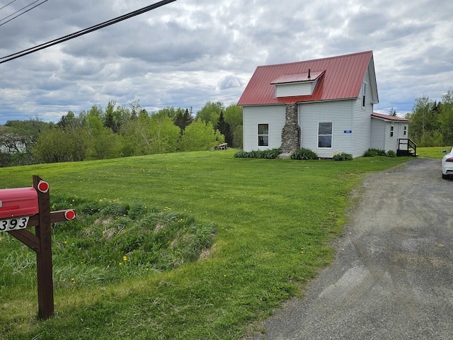 393 Main St, Limestone, ME 04750 - view of home's exterior featuring a yard and metal roof