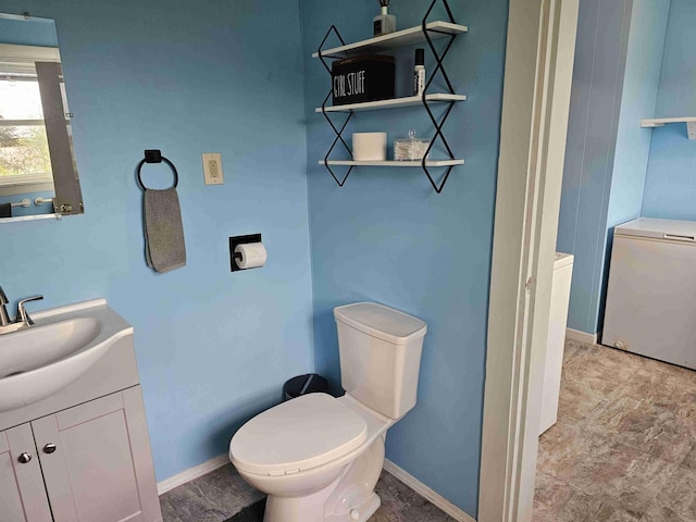 393 Main St, Limestone, ME 04750 - half bath with toilet, vanity, and baseboards