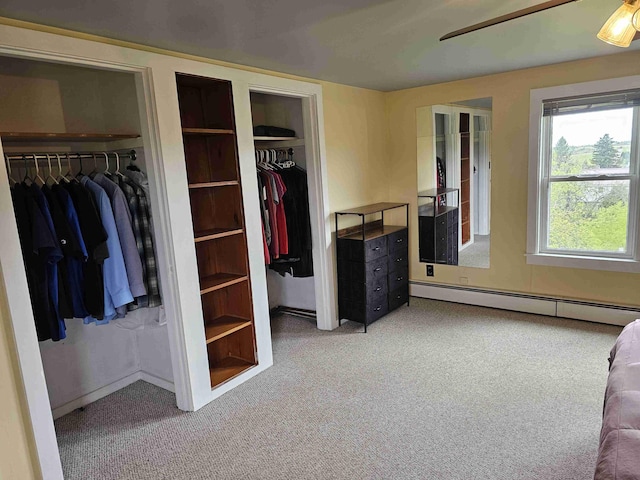 393 Main St, Limestone, ME 04750 - bedroom with multiple closets, carpet, and a baseboard radiator