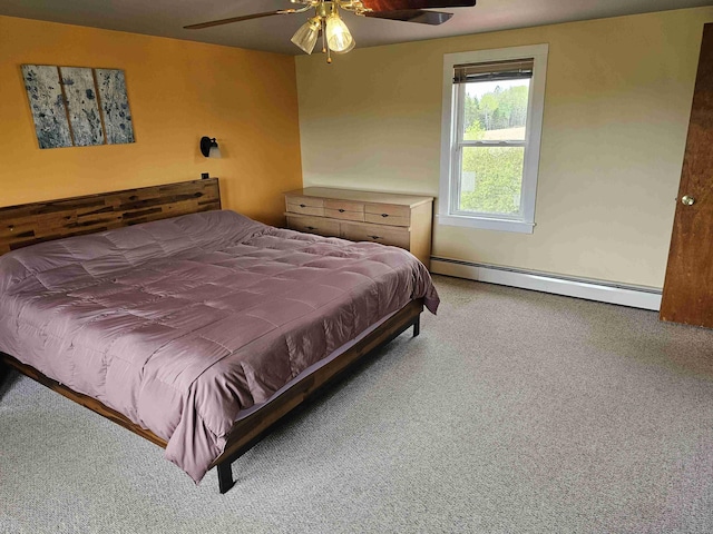 393 Main St, Limestone, ME 04750 - carpeted bedroom featuring baseboard heating and a ceiling fan