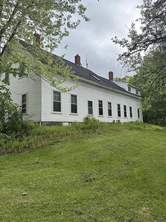 210 Ferguson Rd, Shapleigh, ME 04076 - back of property featuring a chimney and a lawn