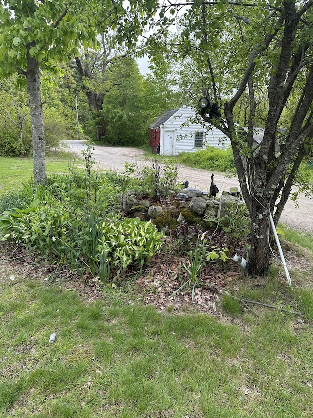 210 Ferguson Rd, Shapleigh, ME 04076 - view of yard with dirt driveway, a garage, and an outbuilding