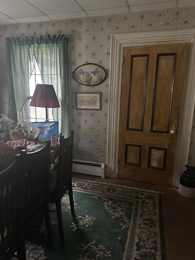 210 Ferguson Rd, Shapleigh, ME 04076 - dining area with baseboard heating, wallpapered walls, and a paneled ceiling