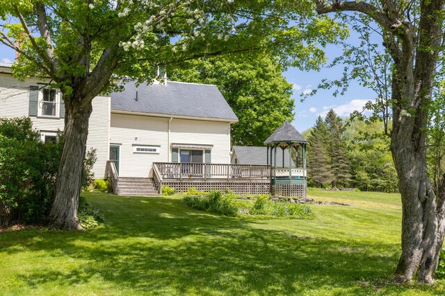 34 Mcphetres Rd, Sangerville, ME 04479 - rear view of property with a deck, a yard, and roof with shingles