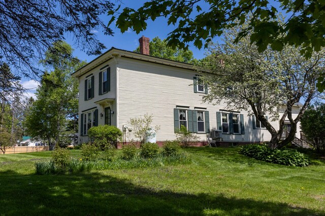 34 Mcphetres Rd, Sangerville, ME 04479 - view of property exterior featuring a chimney and a yard