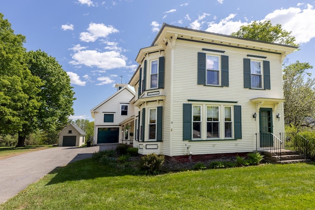 34 Mcphetres Rd, Sangerville, ME 04479 - italianate home featuring a front yard, an outbuilding, and a garage