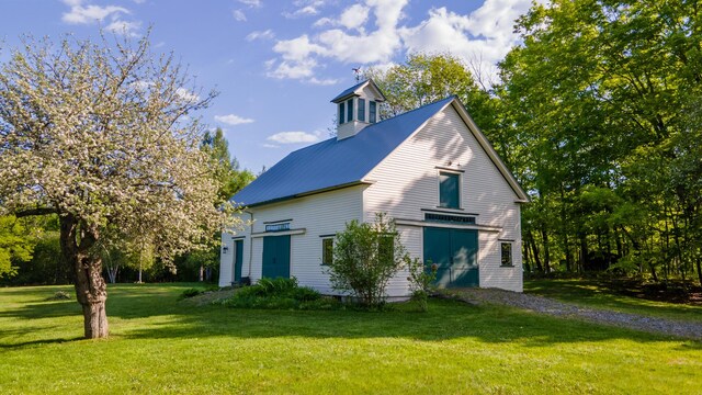 34 Mcphetres Rd, Sangerville, ME 04479 - view of side of home featuring a yard and metal roof