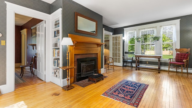34 Mcphetres Rd, Sangerville, ME 04479 - living room with hardwood / wood-style floors, a wood stove, and baseboards