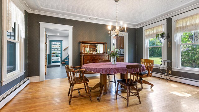 34 Mcphetres Rd, Sangerville, ME 04479 - dining area featuring baseboard heating, wallpapered walls, healthy amount of natural light, a chandelier, and ornamental molding