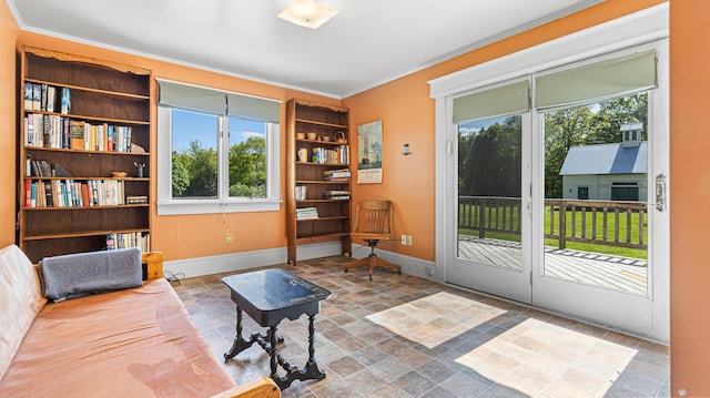34 Mcphetres Rd, Sangerville, ME 04479 - living area featuring healthy amount of natural light, stone finish flooring, ornamental molding, and baseboards