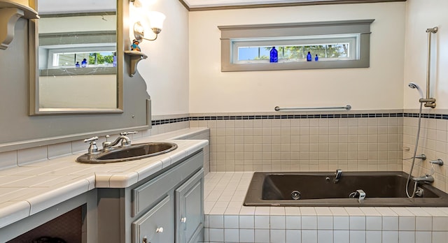 34 Mcphetres Rd, Sangerville, ME 04479 - full bath featuring a whirlpool tub, vanity, a wainscoted wall, and tile walls