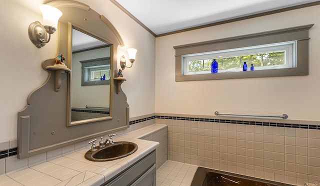 34 Mcphetres Rd, Sangerville, ME 04479 - bathroom with vanity, ornamental molding, a wainscoted wall, and tile walls