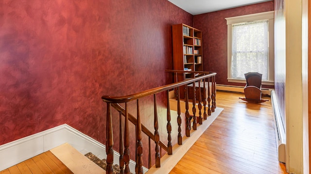 34 Mcphetres Rd, Sangerville, ME 04479 - staircase featuring hardwood / wood-style flooring and a baseboard heating unit