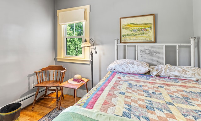 34 Mcphetres Rd, Sangerville, ME 04479 - bedroom featuring wood finished floors and a baseboard heating unit