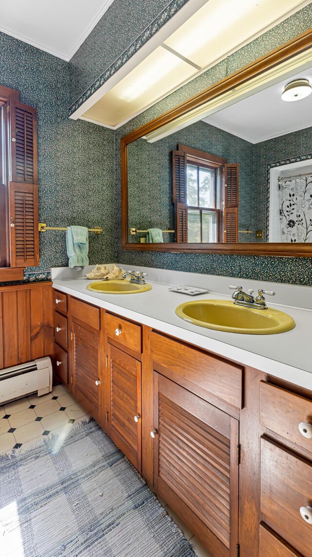 34 Mcphetres Rd, Sangerville, ME 04479 - full bathroom featuring double vanity, a baseboard heating unit, and ornamental molding