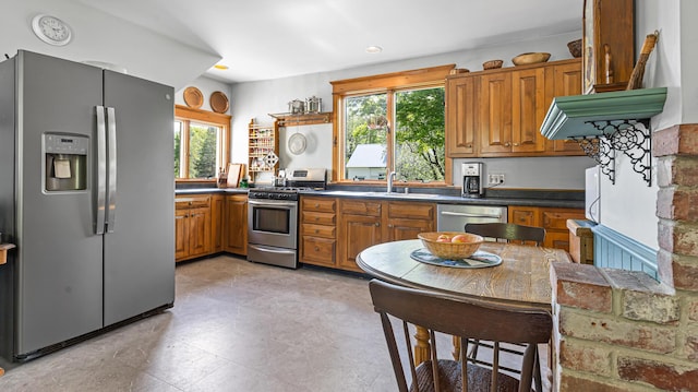 34 Mcphetres Rd, Sangerville, ME 04479 - kitchen with appliances with stainless steel finishes, a sink, brown cabinets, and dark countertops
