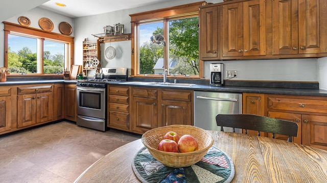 34 Mcphetres Rd, Sangerville, ME 04479 - kitchen with appliances with stainless steel finishes, brown cabinets, plenty of natural light, and dark countertops
