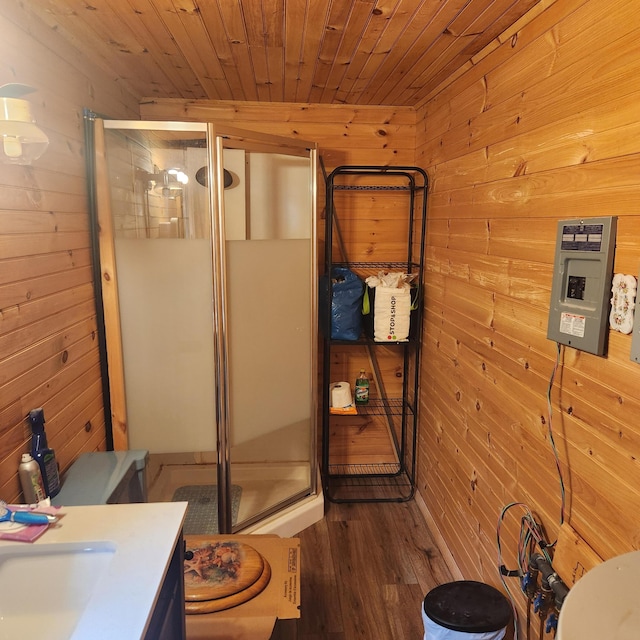 849 N Rd, Medford, ME 04463 - full bath with wooden walls, toilet, a shower stall, vanity, and wood finished floors