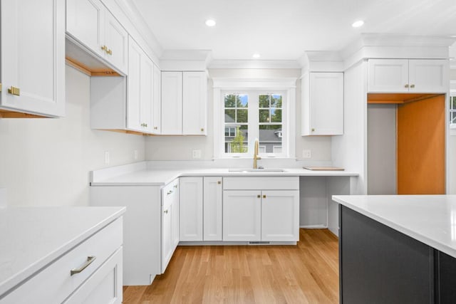 81 Creeks Edge Dr Unit 0, Saco, ME 04072 - kitchen featuring light countertops, white cabinetry, light wood-style flooring, ornamental molding, and recessed lighting