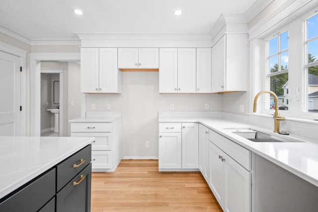 81 Creeks Edge Dr Unit 0, Saco, ME 04072 - kitchen featuring white cabinets, light countertops, crown molding, recessed lighting, and light wood finished floors
