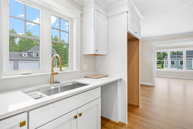 81 Creeks Edge Dr Unit 0, Saco, ME 04072 - kitchen with light wood-style flooring, white cabinets, light countertops, and crown molding