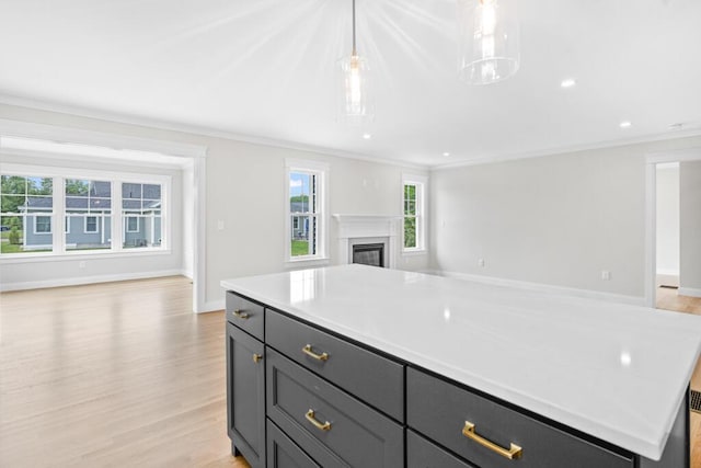 81 Creeks Edge Dr Unit 0, Saco, ME 04072 - kitchen featuring open floor plan, crown molding, light countertops, a center island, and light wood finished floors