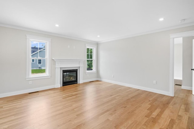81 Creeks Edge Dr Unit 0, Saco, ME 04072 - unfurnished living room with ornamental molding, healthy amount of natural light, light wood-style flooring, a glass covered fireplace, and recessed lighting