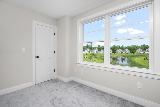 81 Creeks Edge Dr Unit 0, Saco, ME 04072 - empty room featuring light colored carpet, plenty of natural light, and a water view