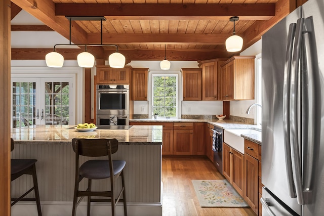 49 Moose Walk Rd, Westport Island, ME 04578 - kitchen featuring appliances with stainless steel finishes, wood ceiling with exposed beams, a sink, light wood-style flooring, and brown cabinetry