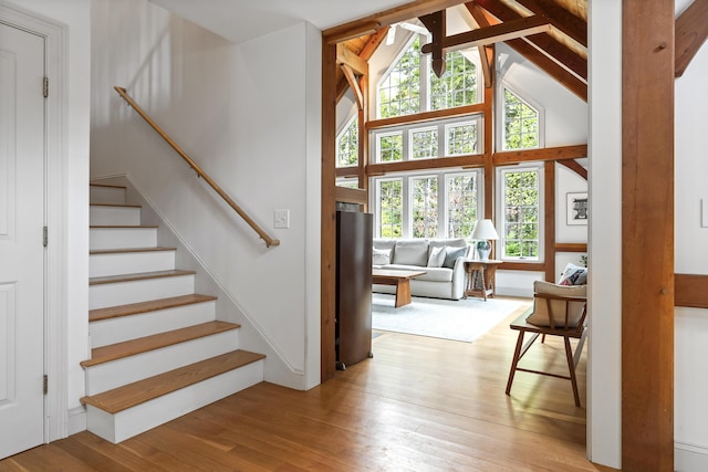 49 Moose Walk Rd, Westport Island, ME 04578 - staircase with wood-type flooring, plenty of natural light, beamed ceiling, and high vaulted ceiling