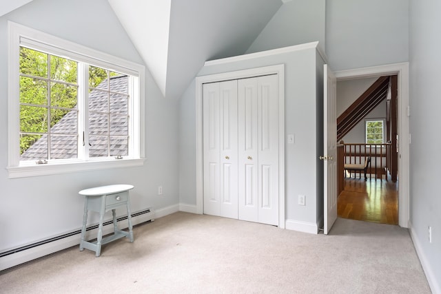 49 Moose Walk Rd, Westport Island, ME 04578 - carpeted bedroom featuring baseboard heating, multiple windows, vaulted ceiling, a closet, and baseboards