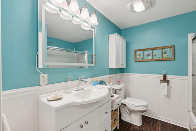 47 Woods Circle Rd, Yarmouth, ME 04096 - bathroom featuring a wainscoted wall, an enclosed shower, vanity, toilet, and wood finished floors