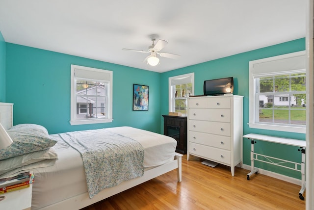 47 Woods Circle Rd, Yarmouth, ME 04096 - bedroom with multiple windows, wood finished floors, ceiling fan, and baseboards