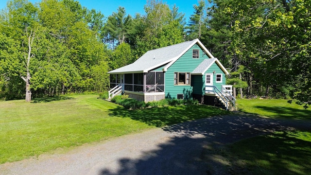 189 Stetson Rd E, Levant, ME 04456 - view of front facade featuring a sunroom, stairway, a front lawn, and driveway