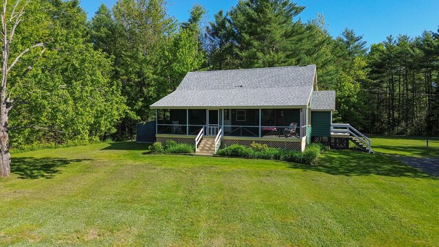 189 Stetson Rd E, Levant, ME 04456 - rear view of property featuring stairway, a sunroom, a lawn, a shingled roof, and a forest view