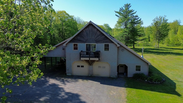 189 Stetson Rd E, Levant, ME 04456 - view of front of house with driveway, an attached garage, a balcony, and a front yard