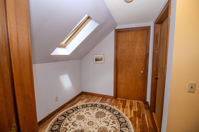 189 Stetson Rd E, Levant, ME 04456 - additional living space with a skylight, light wood-style flooring, lofted ceiling, and baseboards
