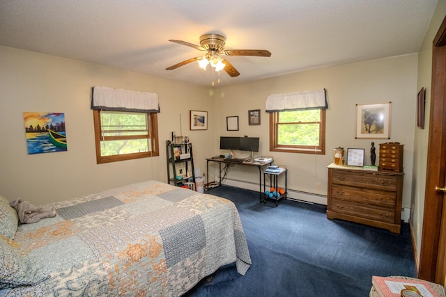 189 Stetson Rd E, Levant, ME 04456 - bedroom featuring dark carpet, a baseboard heating unit, ceiling fan, and an office area