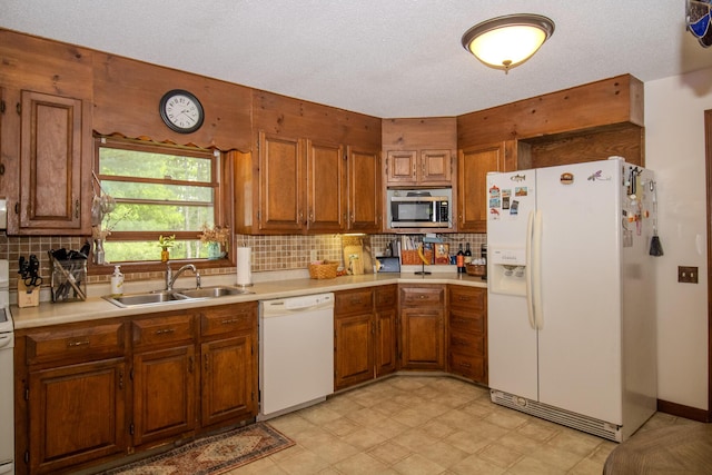 189 Stetson Rd E, Levant, ME 04456 - kitchen with white appliances, a sink, brown cabinets, and a textured ceiling