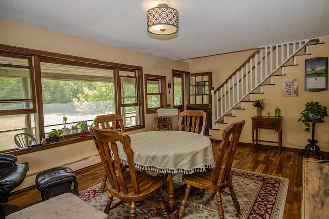 189 Stetson Rd E, Levant, ME 04456 - dining space with stairway, wood finished floors, a textured ceiling, and baseboards