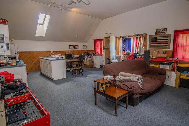 189 Stetson Rd E, Levant, ME 04456 - carpeted living room with a ceiling fan, a skylight, wainscoting, lofted ceiling, and wooden walls