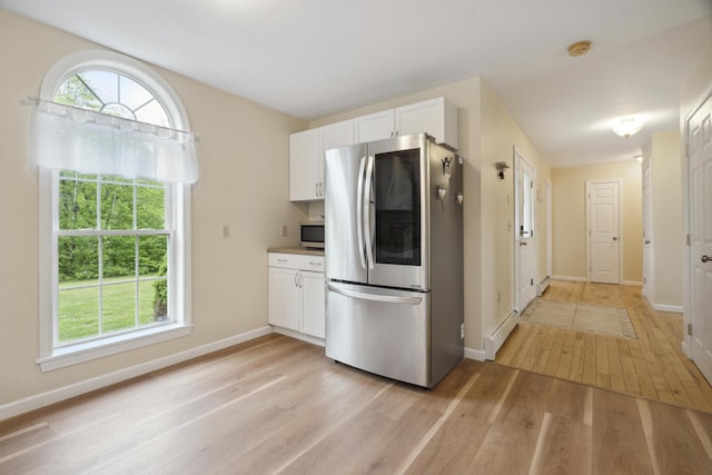 44 Emery Mills Rd, Lebanon, ME 04027 - kitchen featuring stainless steel appliances, baseboard heating, light wood-style floors, and white cabinets