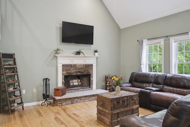 44 Emery Mills Rd, Lebanon, ME 04027 - living area featuring wood-type flooring, a fireplace, high vaulted ceiling, and baseboards