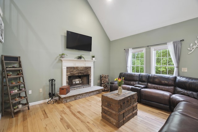 44 Emery Mills Rd, Lebanon, ME 04027 - living area featuring high vaulted ceiling, hardwood / wood-style floors, a stone fireplace, and baseboards