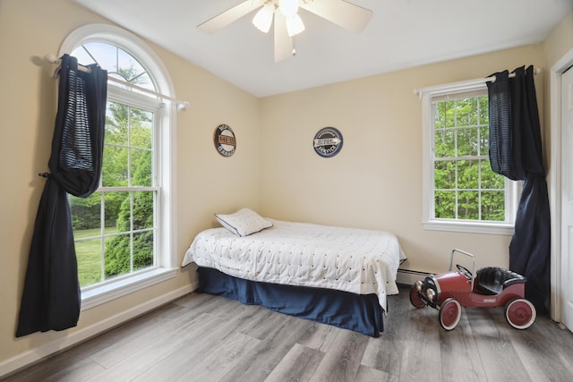 44 Emery Mills Rd, Lebanon, ME 04027 - bedroom with wood finished floors, multiple windows, and lofted ceiling